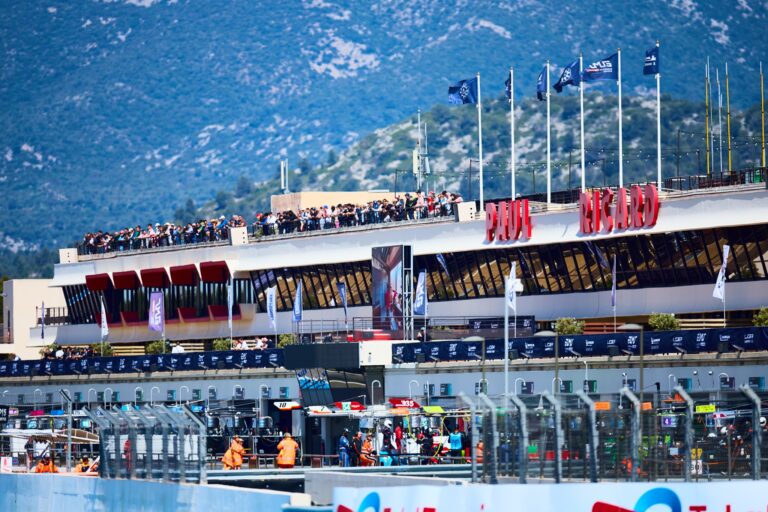 2nd May 2026. Spectators crowd the grandstand roof as teams prepare in the pit lane below, with flags fluttering above the Paul Ricard circuit’s iconic main building. Credit: Craig Allan-McWilliams
